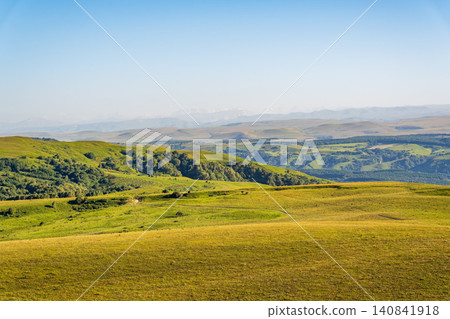 Layers of green mountains and hills in the haze during sunset. Panoramic View of Green hills and Meadow. Layers of green mountains and hills in the haze during sunset. Panoramic View of Green hills and Meadow. 140841918