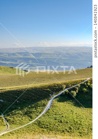 Layers of green mountains and hills in the haze during sunset. Panoramic View of Green hills and Meadow. Layers of green mountains and hills in the haze during sunset. Panoramic View of Green hills and Meadow. 140841923
