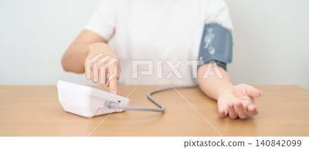 woman checking Blood pressure by Blood pressure monitor with Cuff. Systolic, SYS, Diastolic, DIA, Pulse, Hypertension, Hypotension, Heart rate, Cardiovascular Disease and May World hypertension day woman checking Blood pressure by Blood pressure monitor with Cuff. Systolic, SYS, Diastolic, DIA, Pulse, Hypertension, Hypotension, Heart rate, Cardiovascular Disease and May World hypertension day 140842099
