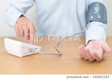 Man checking Blood pressure by Blood pressure monitor with Cuff. Systolic, SYS, Diastolic, DIA, Pulse, Hypertension, Hypotension, Heart rate, Cardiovascular Disease and May World hypertension day Man checking Blood pressure by Blood pressure monitor with Cuff. Systolic, SYS, Diastolic, DIA, Pulse, Hypertension, Hypotension, Heart rate, Cardiovascular Disease and May World hypertension day 140842167