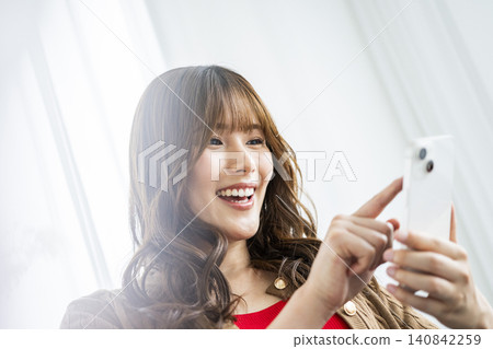 Young woman, smartphone, smiling, search 140842259