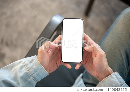 Overhead close up of blank smartphone screen held in both hands suitable for app and website display Overhead close up of blank smartphone screen held in both hands suitable for app and website display 140842355