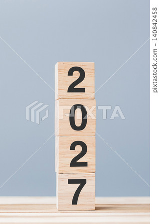 wooden cube block with 2027 text on table background. Resolution, plan, review, goal, start and New Year holiday concepts wooden cube block with 2027 text on table background. Resolution, plan, review, goal, start and New Year holiday concepts 140842458