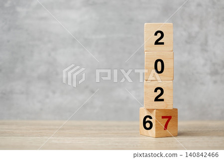 block flipping 2026 to 2027 text on table. Resolution, strategy, plan, goal, motivation, reboot, business and New Year holiday concepts 140842466