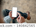 Overhead close up of blank screen smartphone in a man's hand, perfect for mobile app concept display 140842565