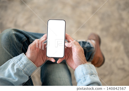 Close up of white smartphone screen held with both hands for app, website and interface presentation Close up of white smartphone screen held with both hands for app, website and interface presentation 140842567
