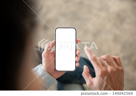 Close up of a person tapping white screen smartphone display, illustrating mobile app interaction. Close up of a person tapping white screen smartphone display, illustrating mobile app interaction. 140842569