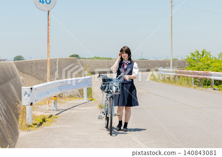 High school girl commuting to school by bicycle 140843081