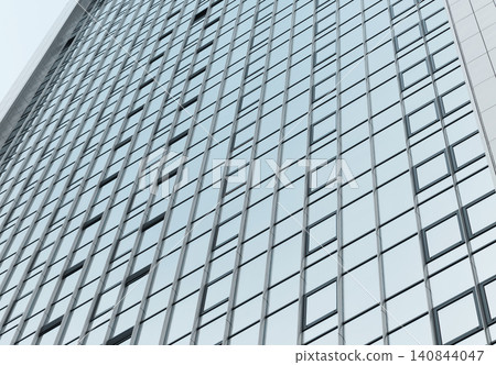 Glass facade of building forms grid pattern against sky. Modern architecture shows repetitive structure with reflective surface. Urban concept reflects design, development, 140844047