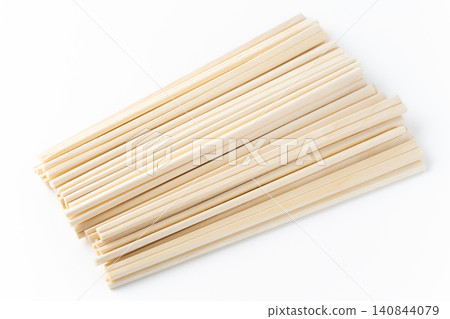 A lot of disposable chopsticks against a white background A lot of disposable chopsticks against a white background 140844079