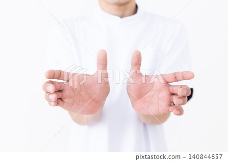 A middle-aged male acupuncturist/osteopath wearing a white coat. A middle-aged male acupuncturist/osteopath wearing a white coat. 140844857