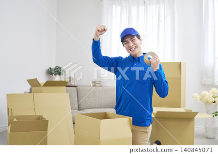 A moving company employee makes a triumphant gesture. 140845071