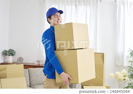 A male moving company worker is exhausted. 140845084