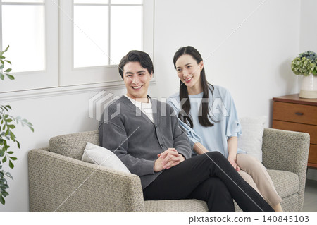 Portrait of a middle-aged couple in their living room. Portrait of a middle-aged couple in their living room. 140845103