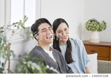 Portrait of a middle-aged couple in their living room. Portrait of a middle-aged couple in their living room. 140845106