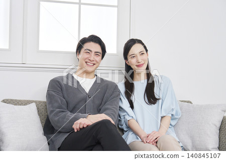 Portrait of a middle-aged couple in their living room. Portrait of a middle-aged couple in their living room. 140845107