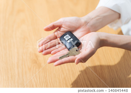 A woman holding car keys. Rental car, delivery, dealer, smart key, wireless key, driver 140845448