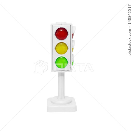 Close up photo of a small traffic light model with a white frame and base. Close up photo of a small traffic light model with a white frame and base. 140845517