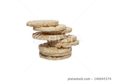 Close up photo of a vertical stack of round rice cakes against a white background. Close up photo of a vertical stack of round rice cakes against a white background. 140845574