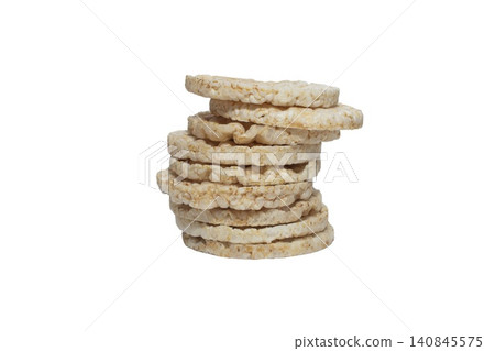 Close up photo of a vertical stack of round rice cakes against a white background. Close up photo of a vertical stack of round rice cakes against a white background. 140845575