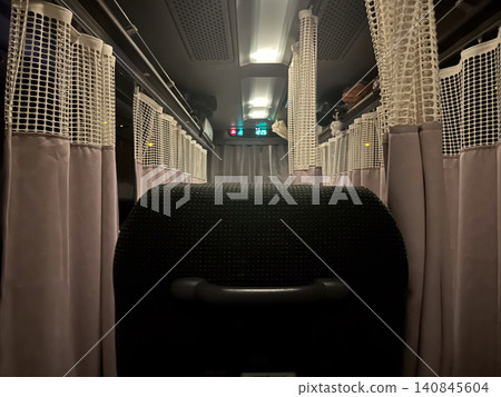 A scene from a late-night overnight bus with three rows of seats. A scene from a late-night overnight bus with three rows of seats. 140845604
