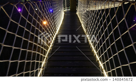 Suspension Bridge at Night with Glowing Lights 140845672