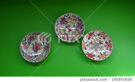 Decorative Plates Floral Designs on Green Wall 140845689