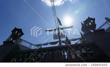 Rooftop view of ship mast against blue sky with bright sun Rooftop view of ship mast against blue sky with bright sun 140845850