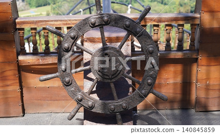 Rusty Ship Wheel with Anchor Detail Rusty Ship Wheel with Anchor Detail 140845859