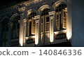 Ornate Building Facade with Windows and Shutters at Night 140846336