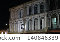 Nighttime Building Facade with String Lights and Moon 140846339