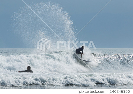 Surfers kicking up waves at Kugenuma Beach, Shonan 140846590