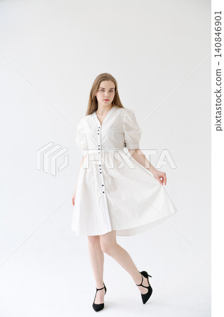 Young Woman in a White Puff Sleeve Dress Full Length Summer Fashion 140846901
