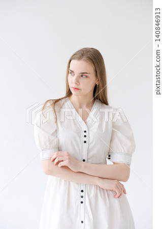 Pensive Young Woman in a White Cotton Dress Thoughtful Studio Portrait Pensive Young Woman in a White Cotton Dress Thoughtful Studio Portrait 140846913