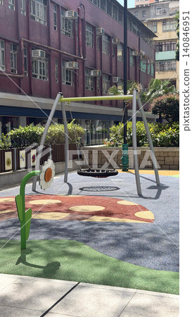 Modern playground swing set with colorful safety surfacing and playful flower decoration Modern playground swing set with colorful safety surfacing and playful flower decoration 140846951