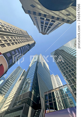 Looking up at modern skyscrapers against a clear blue sky Looking up at modern skyscrapers against a clear blue sky 140847066