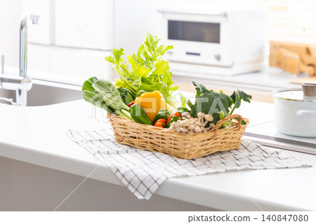 A basket of vegetables placed in the kitchen 140847080