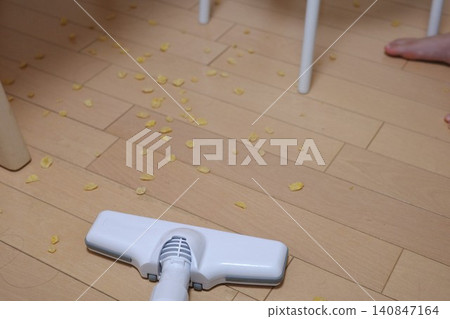 Cleaning up spilled food on the floor. 140847164
