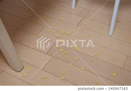 Cornflakes spilled by a child on the floor 140847165