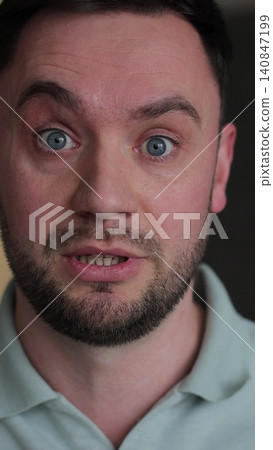 Vertical video Young man showing anger and emotion, expressing frustration and concern, raising his hands. Motions concept. Vertical video Young man showing anger and emotion, expressing frustration and concern, raising his hands. Motions concept. 140847199