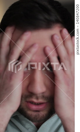 Vertical video Young man showing anger and emotion, expressing frustration and concern, raising his hands. Motions concept. Vertical video Young man showing anger and emotion, expressing frustration and concern, raising his hands. Motions concept. 140847200
