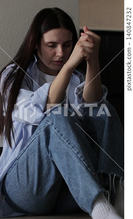Vertical video Woman sitting on kitchen floor crying with head in hands. Family problems, stress. Vertical video Woman sitting on kitchen floor crying with head in hands. Family problems, stress. 140847232