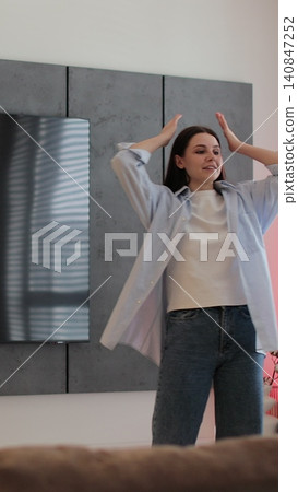 Vertical video Man and woman in discussion, showing emotions of stress in a cozy living room setting. Vertical video Man and woman in discussion, showing emotions of stress in a cozy living room setting. 140847252