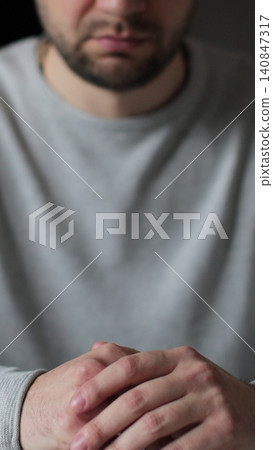 Vertical video Man tired with hands on face physical and emotional discomfort of pressure and stress. Human emotions concept. 140847317
