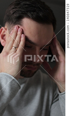 Vertical video Young man tired with hands on face physical and emotional discomfort of pressure and stress. Human emotions concept. Vertical video Young man tired with hands on face physical and emotional discomfort of pressure and stress. Human emotions concept. 140847319