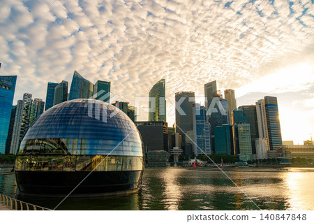 SINGAPORE - JUNE 29, 2025: Wide angle view of the unique Apple Marina Bay Sands spherical store and the iconic central business district skyline SINGAPORE - JUNE 29, 2025: Wide angle view of the unique Apple Marina Bay Sands spherical store and the iconic central business district skyline 140847848