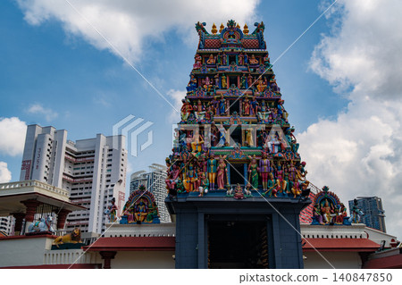 SINGAPORE - JULY 1, 2025: View of the colorful Sri Mariamman Temple's gopuram tower with Hindu deity sculptures under a bright blue sky SINGAPORE - JULY 1, 2025: View of the colorful Sri Mariamman Temple's gopuram tower with Hindu deity sculptures under a bright blue sky 140847850