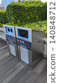 Clean recycling bins installed in a lush green park 140848712