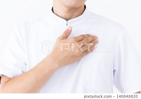 A middle-aged male acupuncturist/osteopath in a white coat presses on acupressure points below the collarbone. A middle-aged male acupuncturist/osteopath in a white coat presses on acupressure points below the collarbone. 140848820