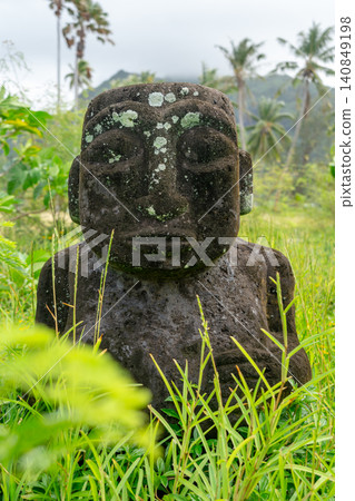 Ancient tiki statue near Coral Garden Beach on Huahine, French Polynesia Ancient tiki statue near Coral Garden Beach on Huahine, French Polynesia 140849198